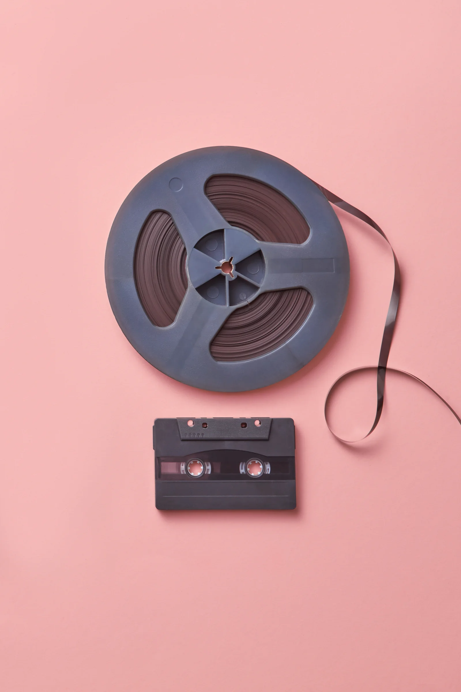 Cine film reel beside an audio cassette — nostalgic family memories worth preserving as a gift