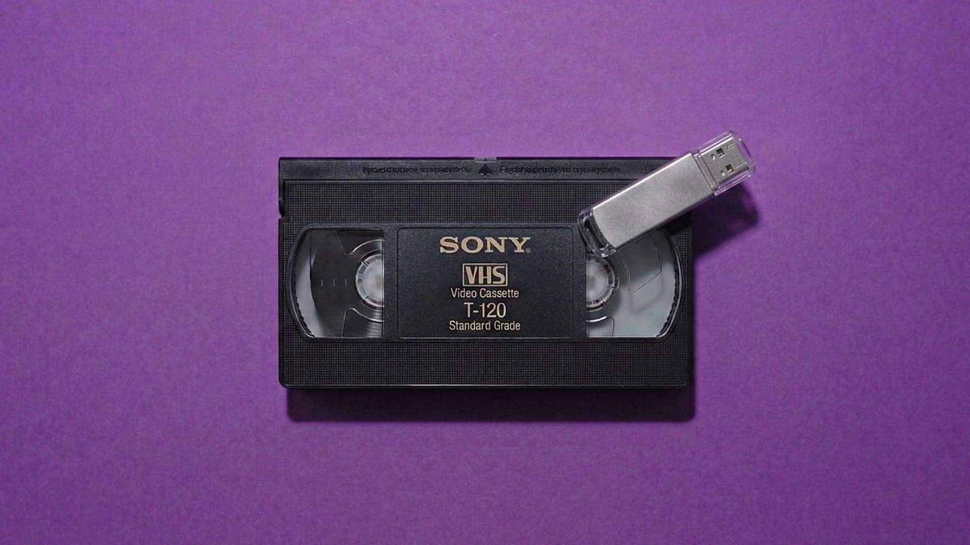 VHS cassette with USB drive — MP4 files delivered on stick or via secure cloud download after conversion