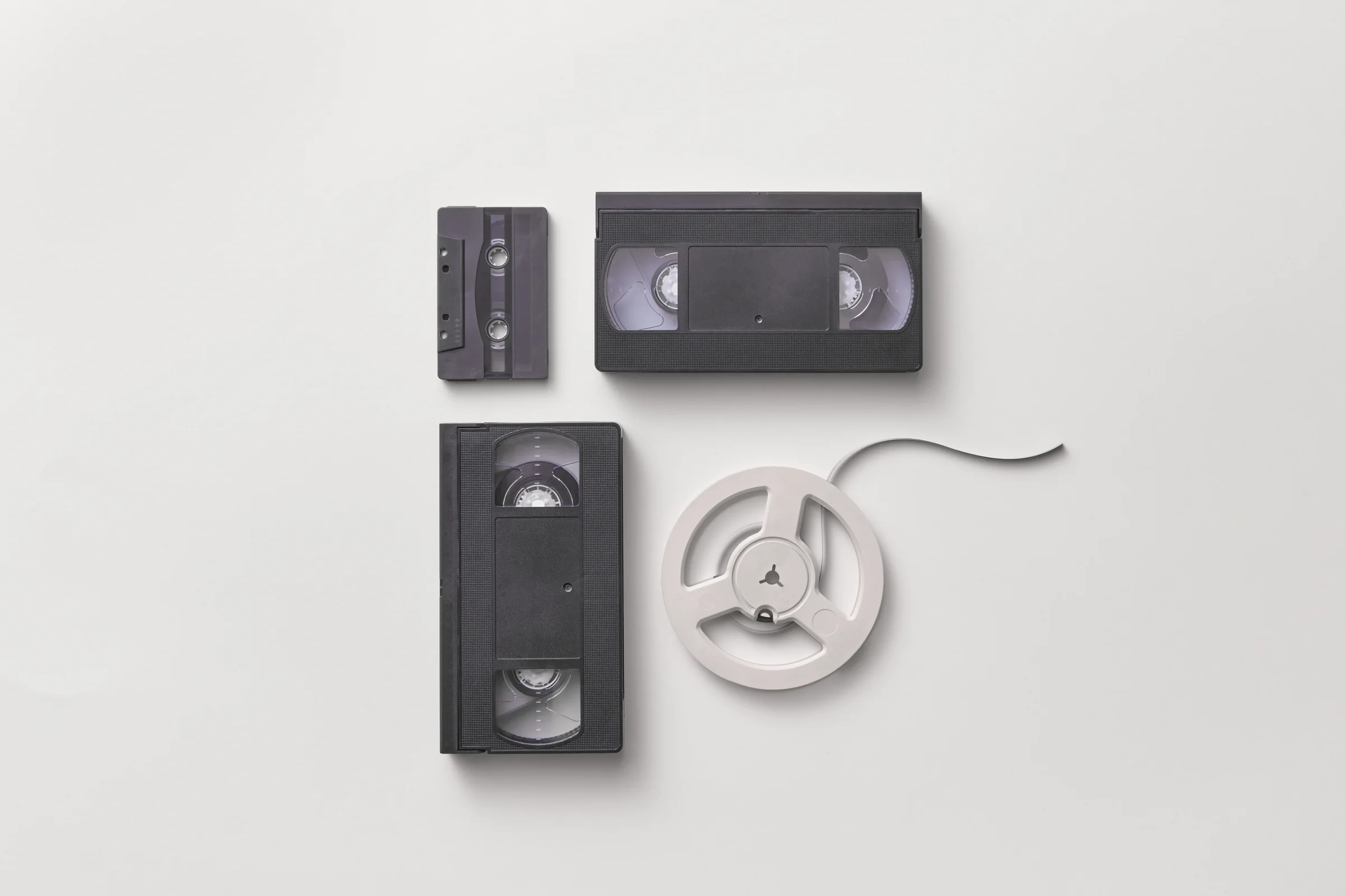 Neatly arranged cassette tape, VHS tapes and film reel